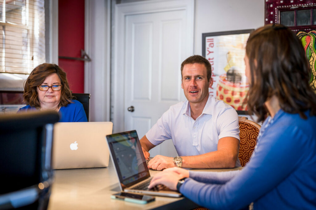 About Us blue million team collaborating over web design client brainstorm